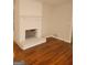 A spacious living room with a fireplace, hardwood floors, and neutral paint, ready for your personal touch at 7588 Covington Hwy, Lithonia, GA 30058