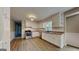 Bright kitchen features white cabinets, stainless steel appliances and wood floors at 11953 Brown Bridge Rd, Covington, GA 30016