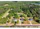 Aerial view of several houses in a wooded area, showcasing the properties and the surrounding landscape at 2955 Peeksville Rd, Locust Grove, GA 30248