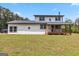 This country farmhouse features a covered wooden porch and a spacious yard at 2955 Peeksville Rd, Locust Grove, GA 30248
