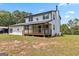 This house features a back porch, a yard and a star hanging on the side at 2955 Peeksville Rd, Locust Grove, GA 30248