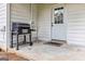 The back porch includes a white door and a black grill, ideal for relaxing and outdoor cooking at 2955 Peeksville Rd, Locust Grove, GA 30248