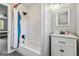 Bathroom featuring a shower-tub combo with gray floors and modern white vanity at 2955 Peeksville Rd, Locust Grove, GA 30248