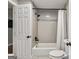 Bathroom featuring tiled shower over tub, white tile, and black fixtures at 2955 Peeksville Rd, Locust Grove, GA 30248