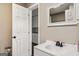 Bathroom with a single vanity, modern faucet, and view to the kitchen at 2955 Peeksville Rd, Locust Grove, GA 30248