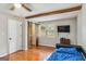Bedroom with wood floors, ceiling fan, sliding barn doors, exposed beam and natural light at 2955 Peeksville Rd, Locust Grove, GA 30248