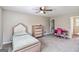 Bedroom offers neutral walls and carpet, a ceiling fan and classic style furniture at 2955 Peeksville Rd, Locust Grove, GA 30248