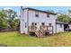 Home exterior featuring white siding, dark trim, and a wooden deck with seating at 2955 Peeksville Rd, Locust Grove, GA 30248