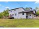 Rear exterior showcasing white siding, dark trim, a deck, and a well-maintained lawn at 2955 Peeksville Rd, Locust Grove, GA 30248