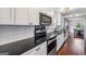 Bright kitchen with all white cabinets, stainless steel appliances and stone countertops at 2955 Peeksville Rd, Locust Grove, GA 30248