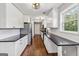 Long kitchen featuring all white cabinets with black countertops and stainless steel appliances at 2955 Peeksville Rd, Locust Grove, GA 30248