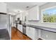 Bright kitchen features all white cabinets, black countertops and stainless steel appliances at 2955 Peeksville Rd, Locust Grove, GA 30248