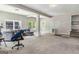 Spacious living room features carpet, a gray sofa, and an open concept design at 2955 Peeksville Rd, Locust Grove, GA 30248