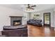 The hardwood-floored living room features a fireplace and comfortable leather seating at 2955 Peeksville Rd, Locust Grove, GA 30248
