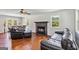 A cozy living room featuring hardwood floors, a fireplace, and leather furniture at 2955 Peeksville Rd, Locust Grove, GA 30248