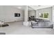 This living room features a large couch, TV, work space and carpeted floors at 2955 Peeksville Rd, Locust Grove, GA 30248