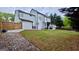 Expansive backyard featuring a lush lawn, complemented by privacy fencing and an inviting outdoor patio area at 303 Sedgewick Trl, Lawrenceville, GA 30044