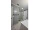 Modern bathroom featuring a glass-enclosed shower, marble countertops, and stylish fixtures at 303 Sedgewick Trl, Lawrenceville, GA 30044