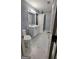 Modern bathroom featuring a glass-enclosed shower, marble countertops, and stylish fixtures at 303 Sedgewick Trl, Lawrenceville, GA 30044