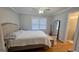 Comfortable bedroom with hardwood floors, and ensuite bathroom with modern fixtures at 303 Sedgewick Trl, Lawrenceville, GA 30044