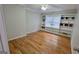Bedroom featuring hardwood floors, ceiling fan, and built-in shelving at 303 Sedgewick Trl, Lawrenceville, GA 30044