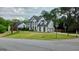 Suburban home featuring a three-car garage on a well-manicured corner lot at 303 Sedgewick Trl, Lawrenceville, GA 30044