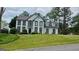 Classic two-story home boasting a well-manicured lawn and charming architectural details at 303 Sedgewick Trl, Lawrenceville, GA 30044