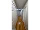 Hallway with multiple doors, hardwood floors, and access to the attic at 303 Sedgewick Trl, Lawrenceville, GA 30044