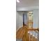 View from staircase landing highlighting the hallway with hardwood floors and multiple doors at 303 Sedgewick Trl, Lawrenceville, GA 30044