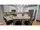 Bright kitchen features granite counters, stainless steel appliances, and seating at the island at 303 Sedgewick Trl, Lawrenceville, GA 30044