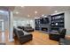 Open-concept living room featuring hardwood floors and custom built-in shelving at 303 Sedgewick Trl, Lawrenceville, GA 30044