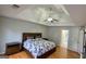 Main bedroom featuring hardwood floors, trey ceiling, and a doorway to an en-suite at 303 Sedgewick Trl, Lawrenceville, GA 30044