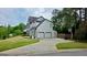 Spacious home featuring a three-car garage and a well-maintained lawn at 303 Sedgewick Trl, Lawrenceville, GA 30044