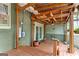 Covered back porch featuring wood flooring, ceiling fan, outdoor lighting, and access to backyard at 2364 Woodside Way, Atlanta, GA 30341