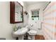 Cozy bathroom featuring a pedestal sink and a shower, offering a functional and bright space at 2364 Woodside Way, Atlanta, GA 30341