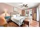 The main bedroom has wood floors, ceiling fan, and open doorway to the laundry at 2364 Woodside Way, Atlanta, GA 30341