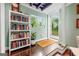 Bright hallway with hardwood floors, a bookcase, and an entrance to the backyard at 2364 Woodside Way, Atlanta, GA 30341