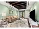 Cozy living room with exposed ceiling beams, a comfortable seating area, and a large screen television at 2364 Woodside Way, Atlanta, GA 30341
