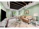 Finished living room with exposed ceiling beams, ample seating, and seamless access to the backyard at 2364 Woodside Way, Atlanta, GA 30341