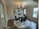 Dining room with hardwood floors, modern chandelier, and large windows at 783 Lost Creek Cir, Stone Mountain, GA 30088