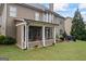 Cozy screened-in porch adjacent to a stone patio with outdoor seating and barbecue area at 4769 Moon Hollow Ct, Buford, GA 30519