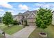 Beautiful brick home with a well-kept lawn, two-car garage, and a serene landscaped garden at 4769 Moon Hollow Ct, Buford, GA 30519