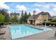 Community pool area with chairs, landscaping, and a small building for residents' enjoyment at 4769 Moon Hollow Ct, Buford, GA 30519