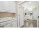 Bathroom with white cabinets and drawers leading to the main bathroom with double sinks at 1979 Alcovy Shoals Blf, Lawrenceville, GA 30045