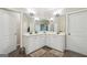 Bright bathroom with double sinks, white cabinets, and ample counter space and a separate shower at 1979 Alcovy Shoals Blf, Lawrenceville, GA 30045