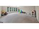 Large, sunlit bonus room with neutral carpet and a wall of windows overlooking the trees at 1979 Alcovy Shoals Blf, Lawrenceville, GA 30045