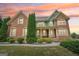 Charming two-story brick home featuring manicured landscaping and a welcoming front porch at 1979 Alcovy Shoals Blf, Lawrenceville, GA 30045