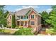 Beautiful two story brick home with green and brown accents, and mature landscaping at 1979 Alcovy Shoals Blf, Lawrenceville, GA 30045