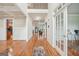 Bright hallway with gleaming wood floors and coffered ceilings, offering a view of the home's layout at 1979 Alcovy Shoals Blf, Lawrenceville, GA 30045