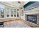 Inviting living room featuring coffered ceiling, a stone fireplace, and an abundance of natural light at 1979 Alcovy Shoals Blf, Lawrenceville, GA 30045